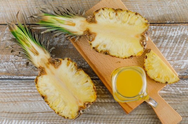 Pineapple slices with juice flat lay on cutting board