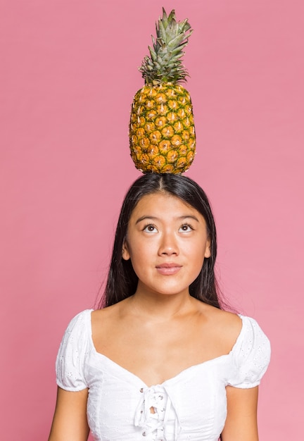 Free photo pineapple on top of a woman head