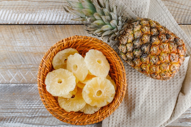 Free photo pineapple with candied rings on kitchen towel