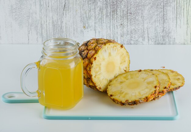 Pineapple with juice on cutting board