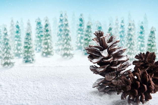 Pinecone on the snow with snowy fir trees background. Christmas decoration