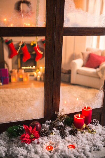 Pinecones on fake snow and canddles