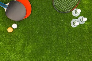 ping-pong balls; shuttlecock; badminton and rackets on green turf