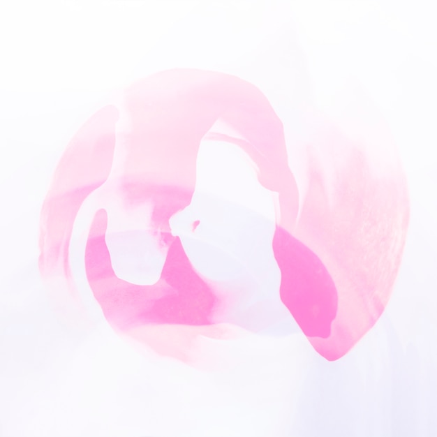 Free photo pink abstract watercolor background with paper texture