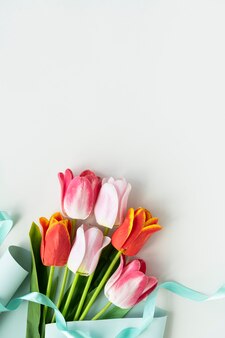 Розовые и оранжевые тюльпаны на пустом белом фоне шаблона