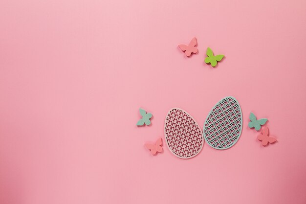 Pink background with butterflies and eggs for easter