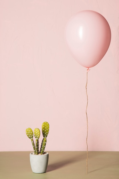 Free photo pink balloon and cactus