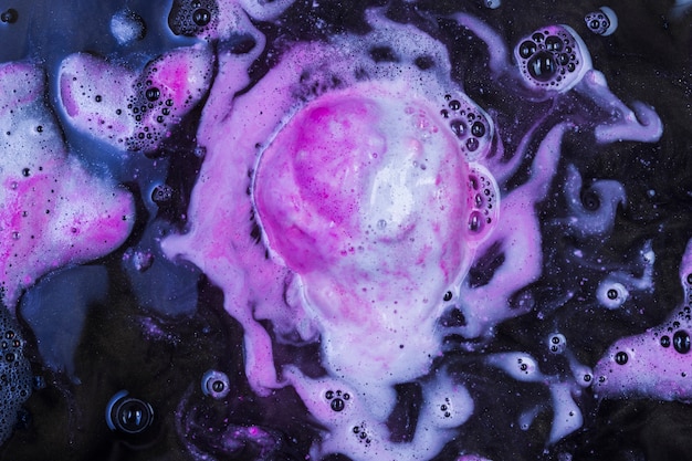 Pink bath bomb in water