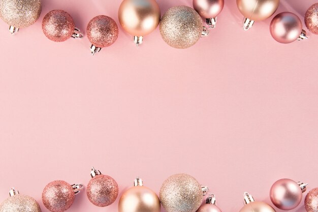 Pink baubles in row on pink