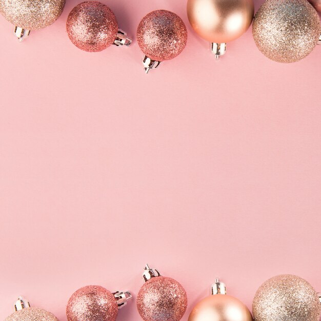 Pink baubles in row on pink