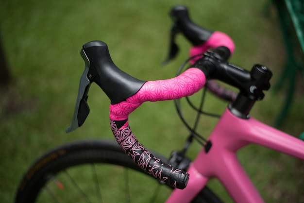 Pink bike leaning on park bench