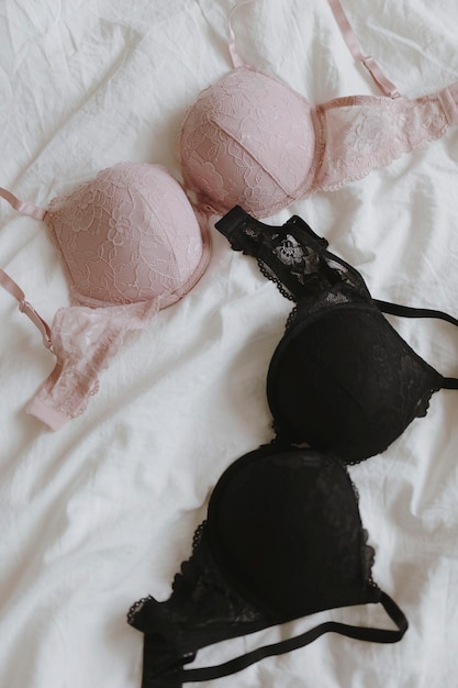 Free photo pink and black bras on a bed