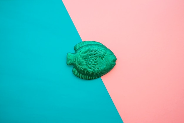 Free photo pink and blue surface with green fish