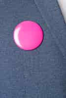 Free photo pink brooch on blue blazer