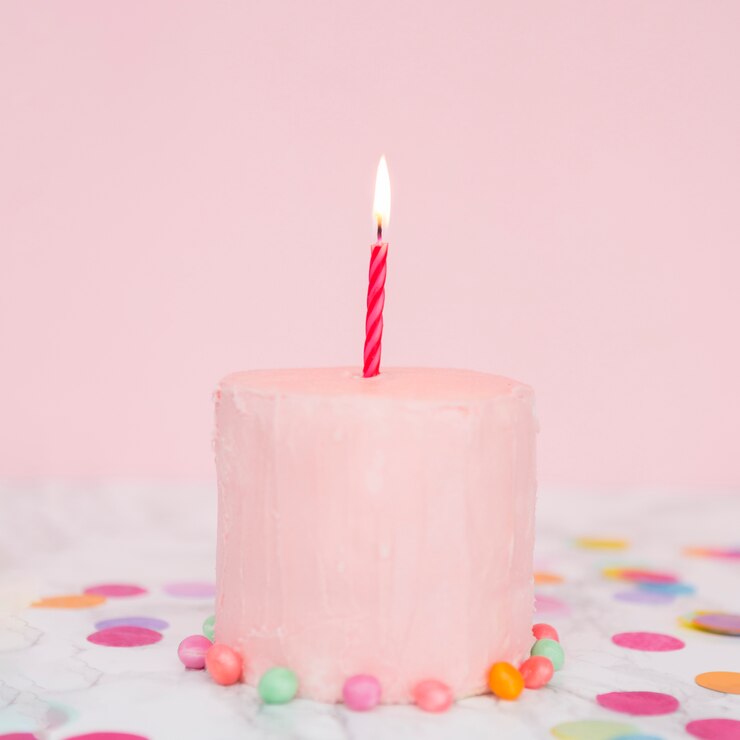 Free Photo pink cake with lit candle