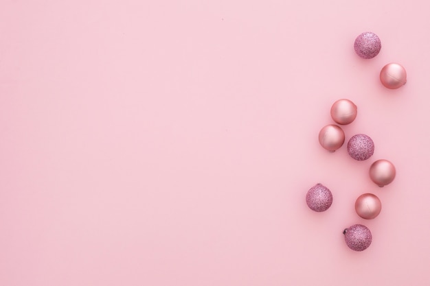 Pink christmas balls on a pink background