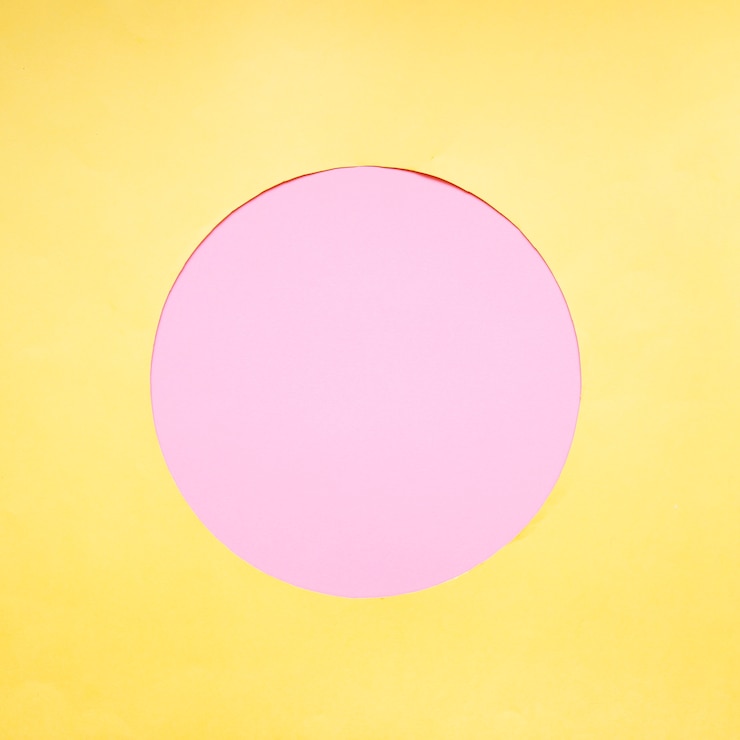 Free Photo pink circle on yellow background