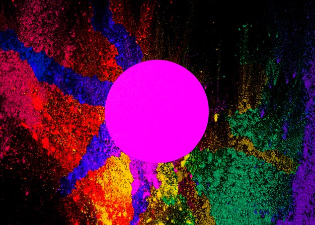 pink circular frame on dry holi powder over the black background