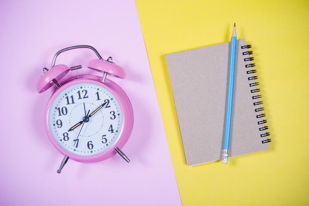 Pink Clock on the colorful background, Education Concept