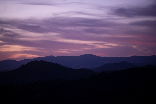 Pink clouded sky with mountains
