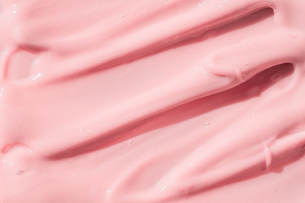 Розовый цвет косметический крем лосьон увлажняющий крем мазок пятно образец красоты крем текстура фон