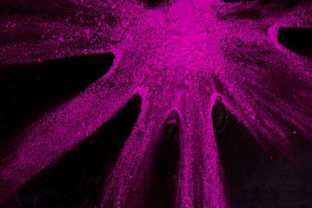 Pink color powder on black backdrop