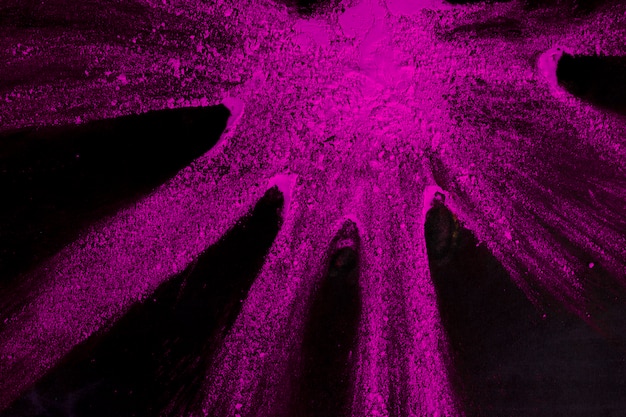 Pink color powder on black backdrop