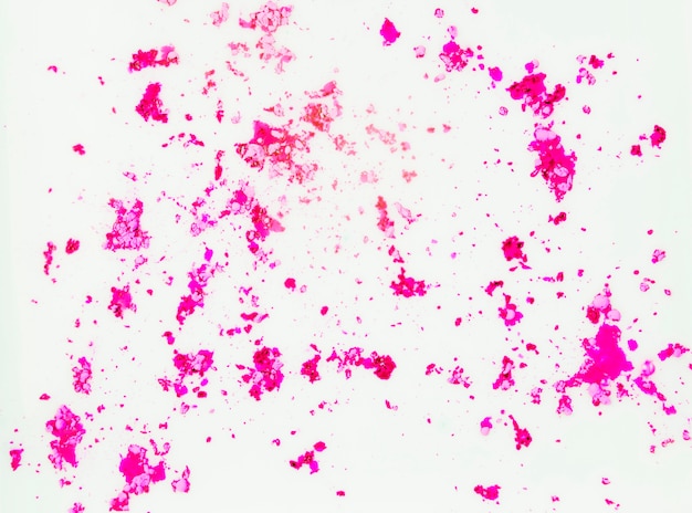 Free photo pink color powder on white surface backdrop