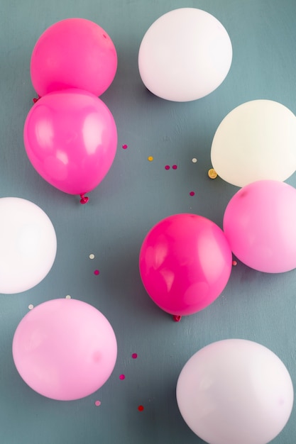 Pink colored balloons on floor