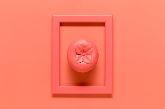 Pink composition with fruit in frame on colored background