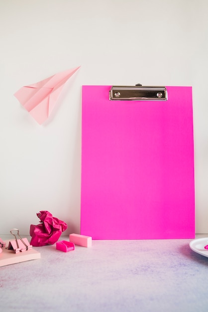 Pink composition with office tablet on table