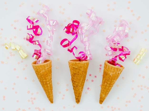 Free photo pink confetti on ice cream cones