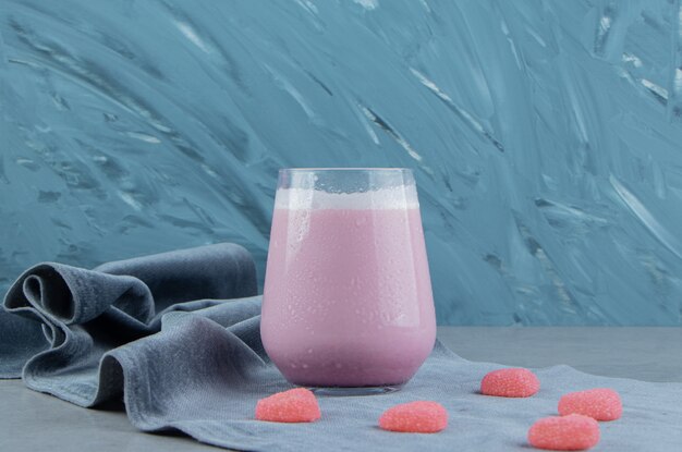 Pink cookie and milk shake on the towel, on the marble background. High quality photo