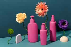 Free photo pink cosmetic products and flowers