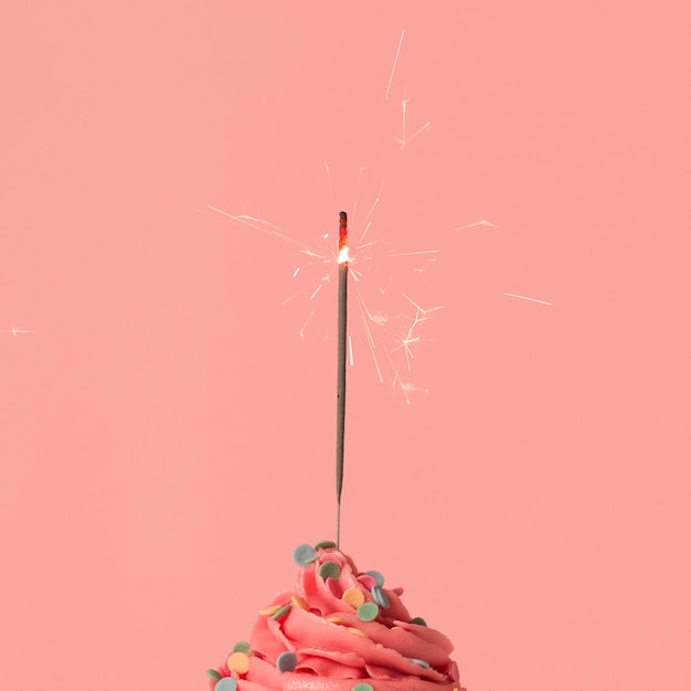 Free photo pink cupcake with sparkler
