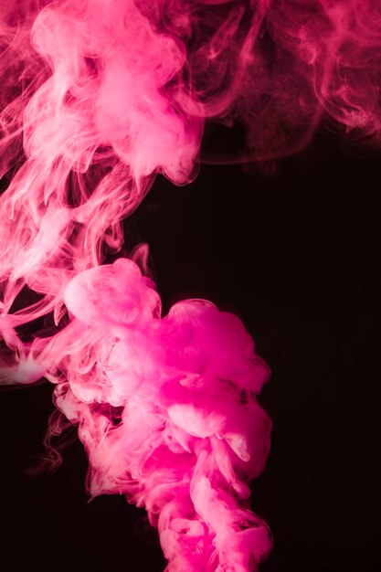 Pink dense smoke on the black background