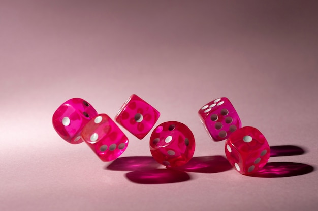 Free photo pink dices on pink background