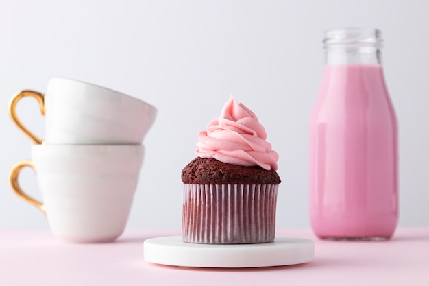 Free photo pink drink, cupcake and cups