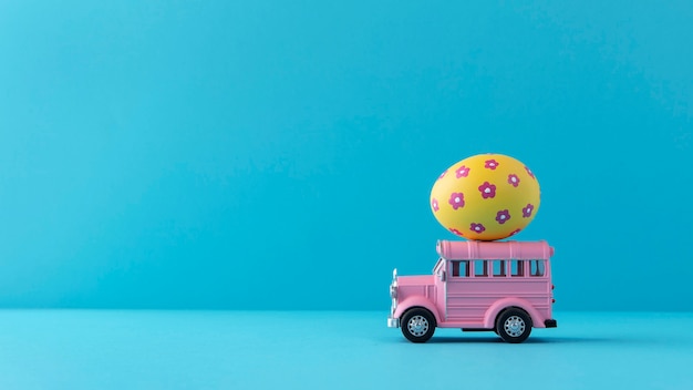 Pink easter car with floral egg still life