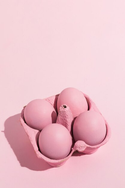 Pink Easter eggs in rack on table