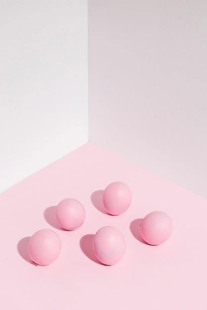 Pink Easter eggs scattered on table