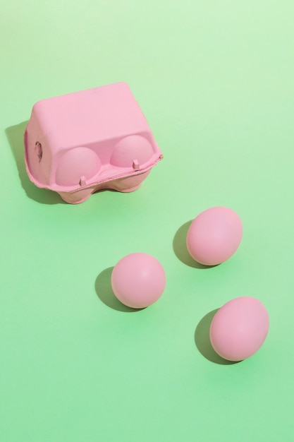 Free photo pink eggs with small rack on table