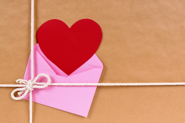 A pink envelope with a heart