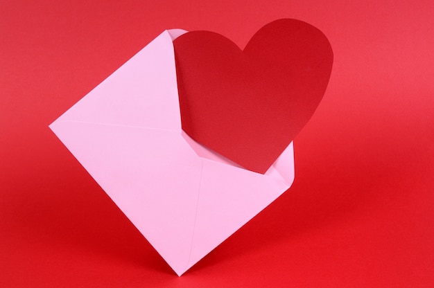 A pink envelope with a red heart