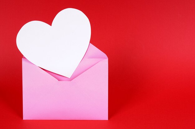 A pink envelope with a white heart