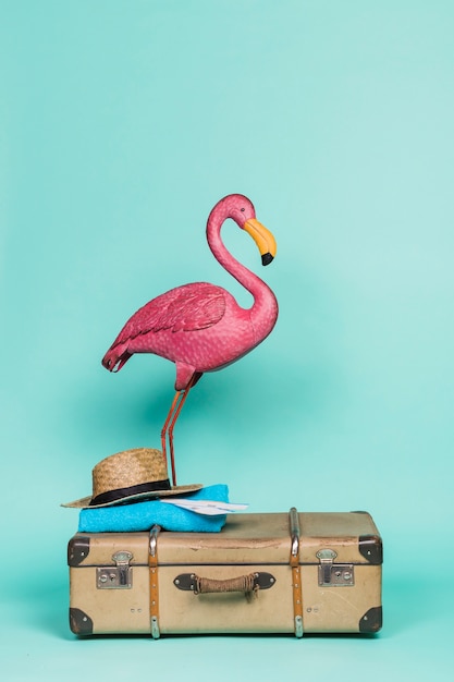 Free photo pink flamingo on travel accessories