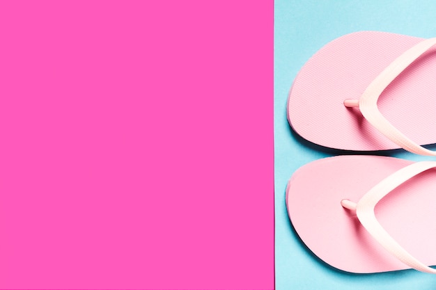 Pink flip-flops on colorful surface