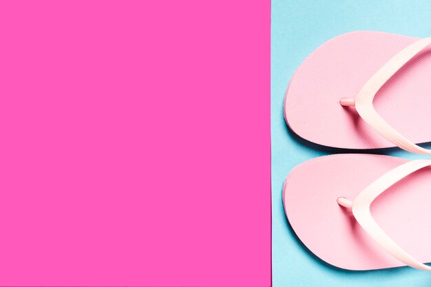 Pink flip-flops on colorful surface