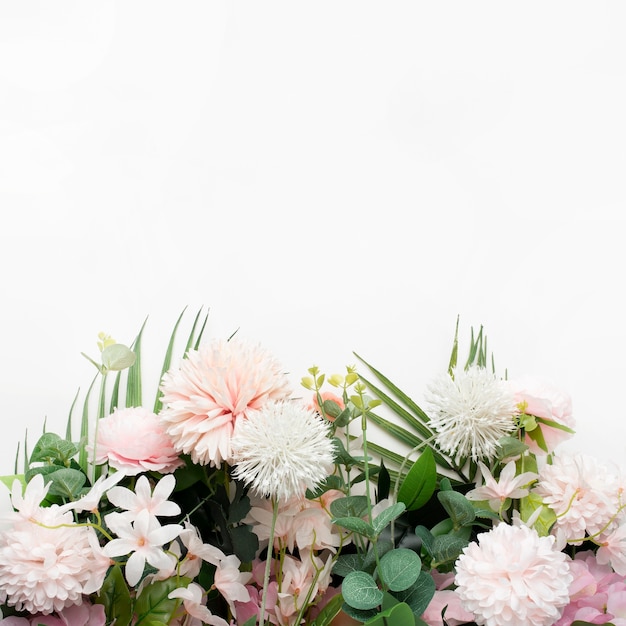 Pink flower border with palm leaves on white background