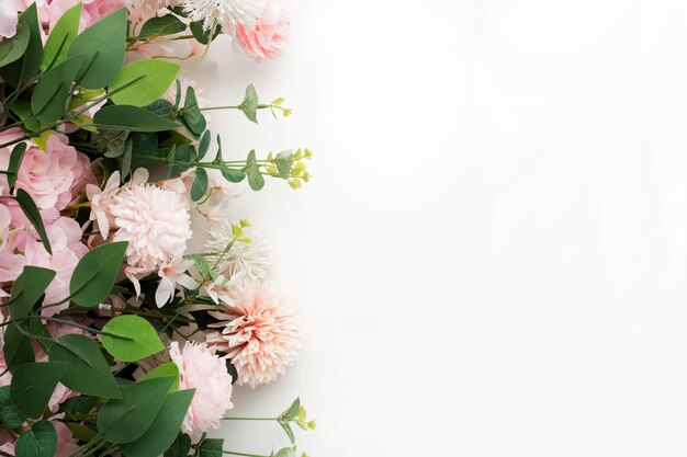 Pink flower border with palm leaves on white background